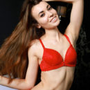 Rosie Lauren displays her naked, petite body as she poses on the bed.