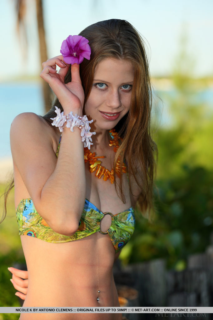 Wearing a matching tropical print bikini, Nicole K makes the perfect company for your erotic paradise getaway.