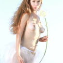 Erica B portrays a delicate maiden in her white tutu skirt that highlights her natural beauty and youthful allure.