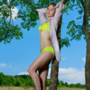 Elisa Liv strips her lime green lingerie baring her nubile body on the grassy field.