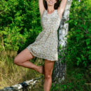 Yasmina strips in the forest baring her perky tits and flexible body.