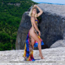 Libby grabs her meaty ass as she flaunts her sexy body on the cliff.