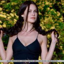 Seductive Martina Mink shows off her luscious body and big tits as she strips outdoors.