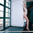 Viviann sensually poses by window as she bares her sexy, slender body.