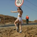 Young girl undresses in front of road workers