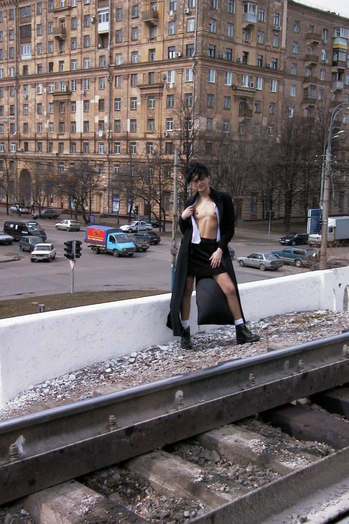 Nude russian brunette posing at railroad