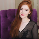 Redhead Jia Lissa flaunts her sweet pussy ass he poses on the chair.