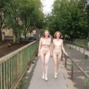 Two completely naked red-haired girls on city streets