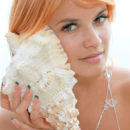 Violla evokes a stunning nymph as she confidently perch on a large round, overlooking a breathtaking view.