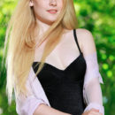 Wearing a black one-piece bikini and sheer long-sleeved top, Fay Love emphasizes her stunning, porcelain skin, and long, fuzzy thighs.