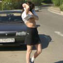 A young girl walks naked through the city streets