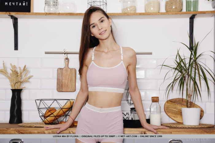 Amazing model Leona Mia bares her tight body and sweet pussy in the kitchen.