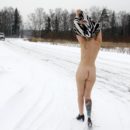 Blonde undresses on the side of the winter road