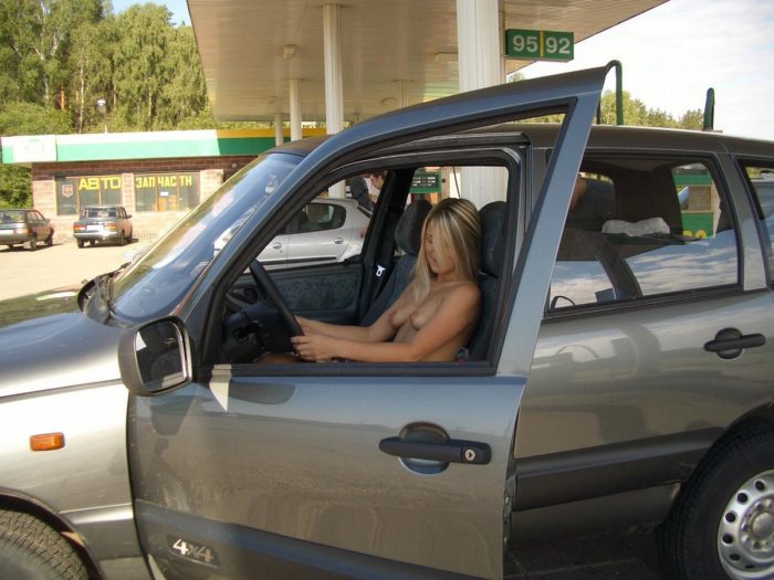 Girl without clothes at a gas station