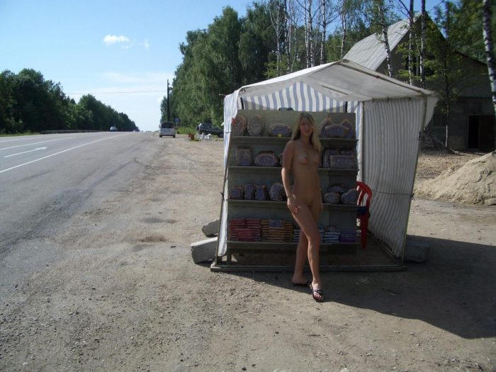 Girl without clothes at a gas station