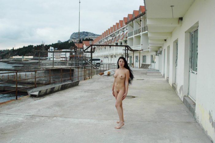 Hot russian brunette posing naked on embankment