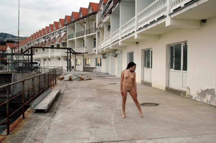 Hot russian brunette posing naked on embankment
