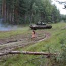 Long-haired russian girl posing at tank test site