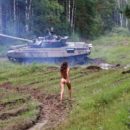 Long-haired russian girl posing at tank test site