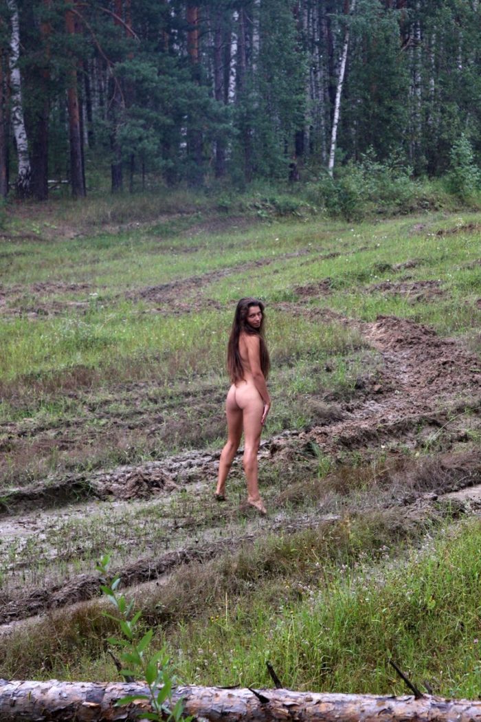 Long-haired russian girl posing at tank test site