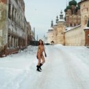Redhead girl wears only boots and gloves at winter streets