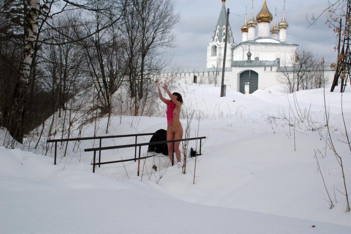 Russian babe plays with snow on small bridge