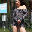 Russian girl undresses near military facility