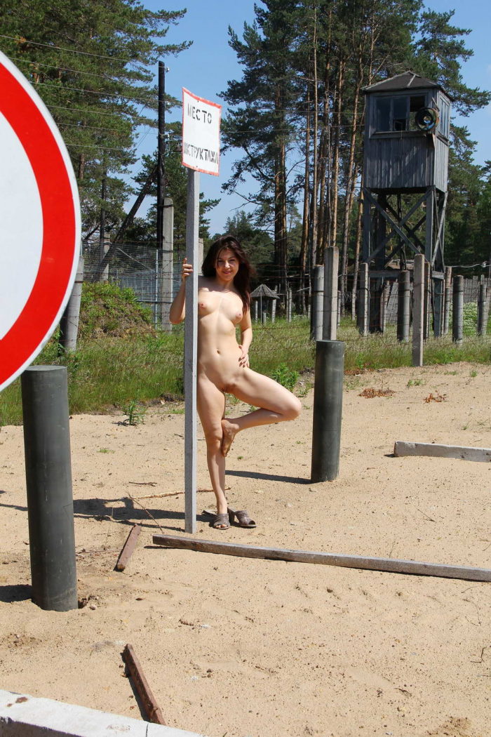 Russian girl undresses near military facility