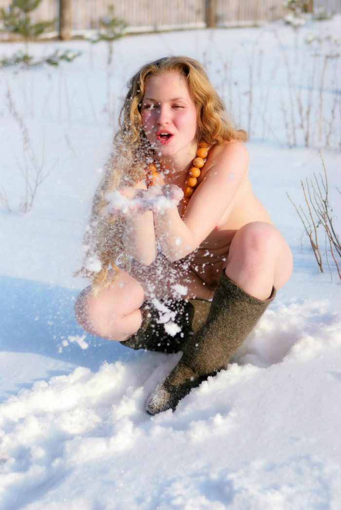 Two young girls plays with snow after sauna session