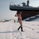 Undressed girl walks on a frosty morning