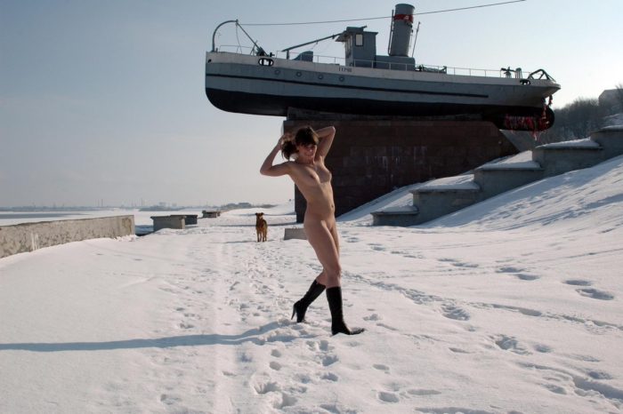 Undressed girl walks on a frosty morning