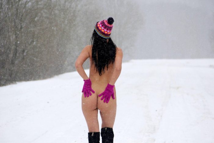 Almost naked brunette at snowy road