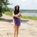 Brunette Veronica Snezna removes her purple dress to show pussy