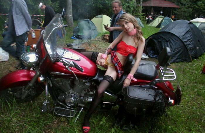 Crazy russian blonde posing in front of many bikers