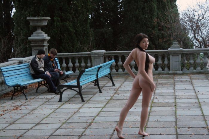 Naked busty girl walks around the sights