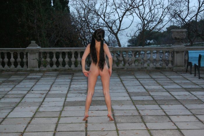 Naked busty girl walks around the sights