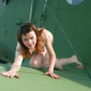 Naked girl on the wing of an old plane