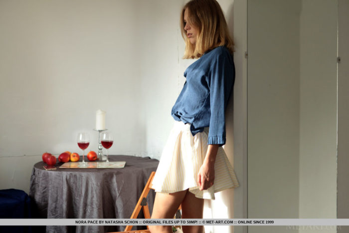 Nora Pace poses by the window as the sunset touches her amazing body.