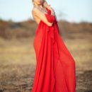 Alluring Aljena A draped in red silk. Watch as she unwraps her lovely lithe body exposing her small perky breasts and lovely round buttocks.