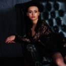 Winona shamelessly spreads her legs and bares her untrimmed pussy in a variety of erotic   poses on top of the black leather couch.