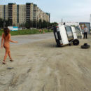 Beautiful girl Oksana E near a repaired car