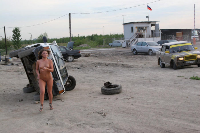 Beautiful girl Oksana E near a repaired car