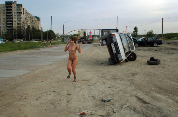 Beautiful girl Oksana E near a repaired car