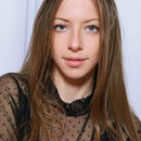 Blue-eyed darling Mika A with long brown hair, long and slender physique, and perky assets