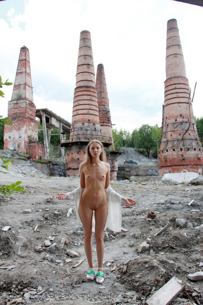 Slim blonde Nimfa posing naked at tourist place