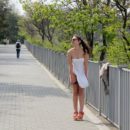 Smiling russian girl walks naked at public park