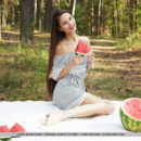 Top model Leona Mia bares her petite body and pink pussy as she eats her watermelon.