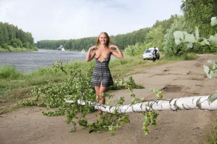 Beautiful blonde Sarika posing near the river