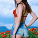 Gabriele strips in the flowery field as she flaunts her slender body.