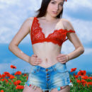 Gabriele strips in the flowery field as she flaunts her slender body.
